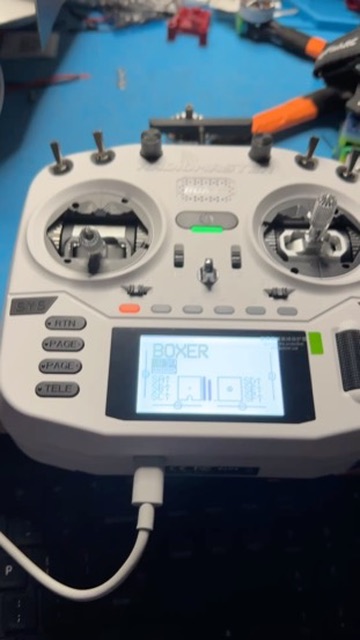 RadioMaster Boxer radio on the bench, powered on and charging over USB-C.